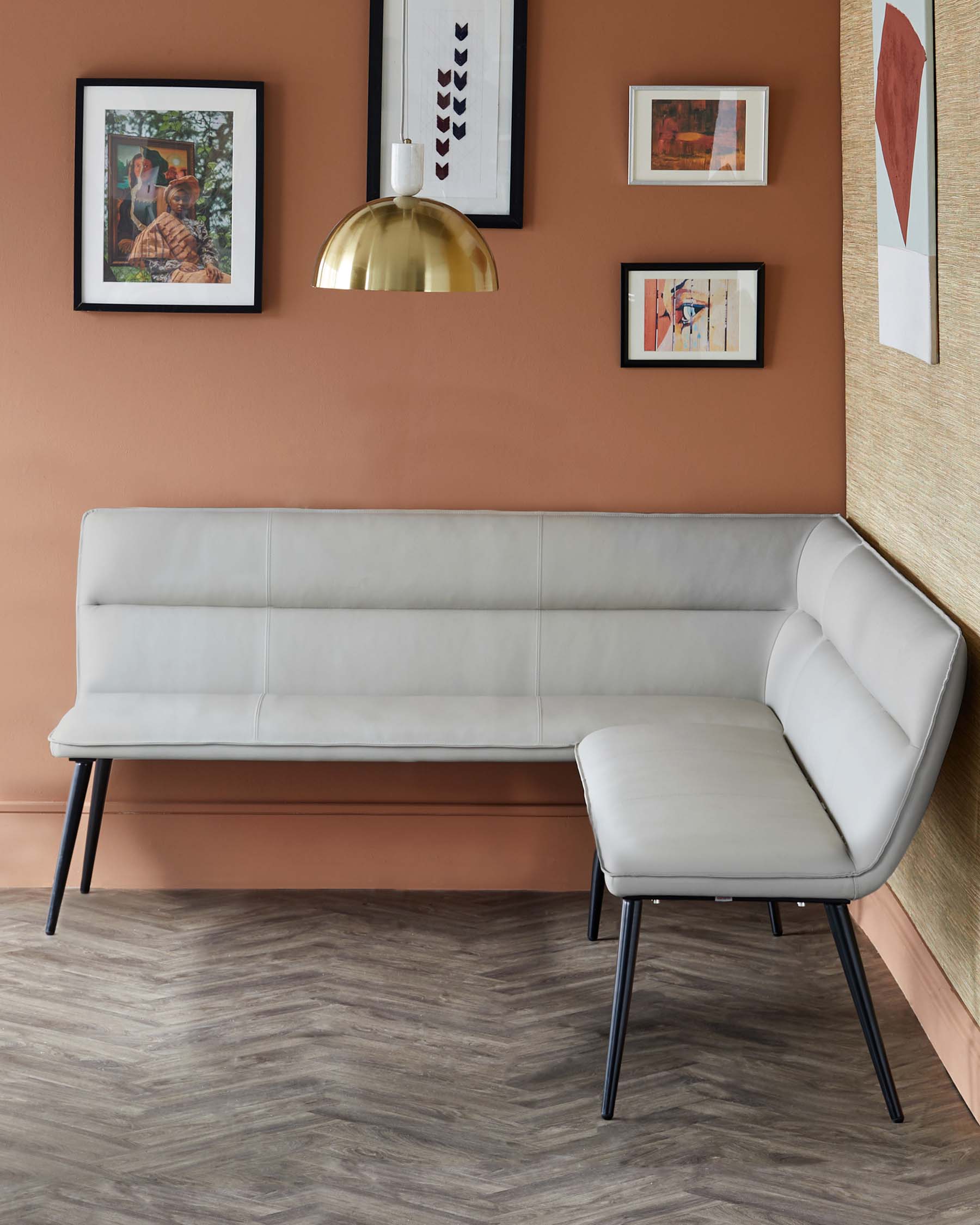 Stylish, modern light gray bench with clean lines and black legs, paired with a matching side seat against a warm-colored wall.