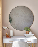 Elegant white ribbed console table with brass handles and legs, paired with a soft white textured stool with a rounded silhouette and brass base.