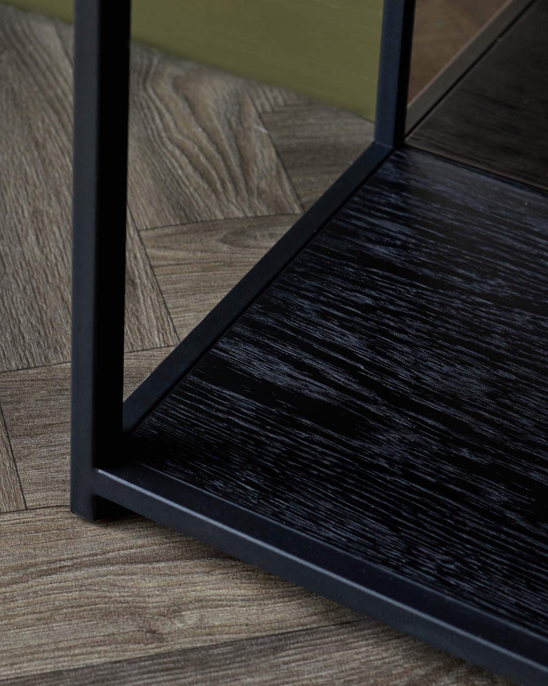 A modern black metal frame showcasing a sleek, textured dark wood shelf, complementing a stylish interior design.