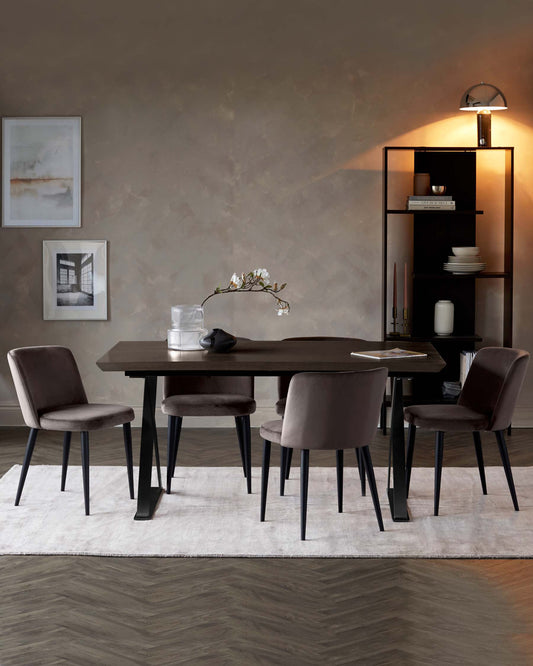 A sleek black dining table with four plush gray chairs, complemented by a modern shelving unit and soft lighting.