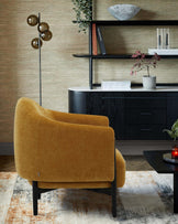 A mustard yellow accent chair, modern shelf with decor, and a sleek black console, complemented by soft rug textures.