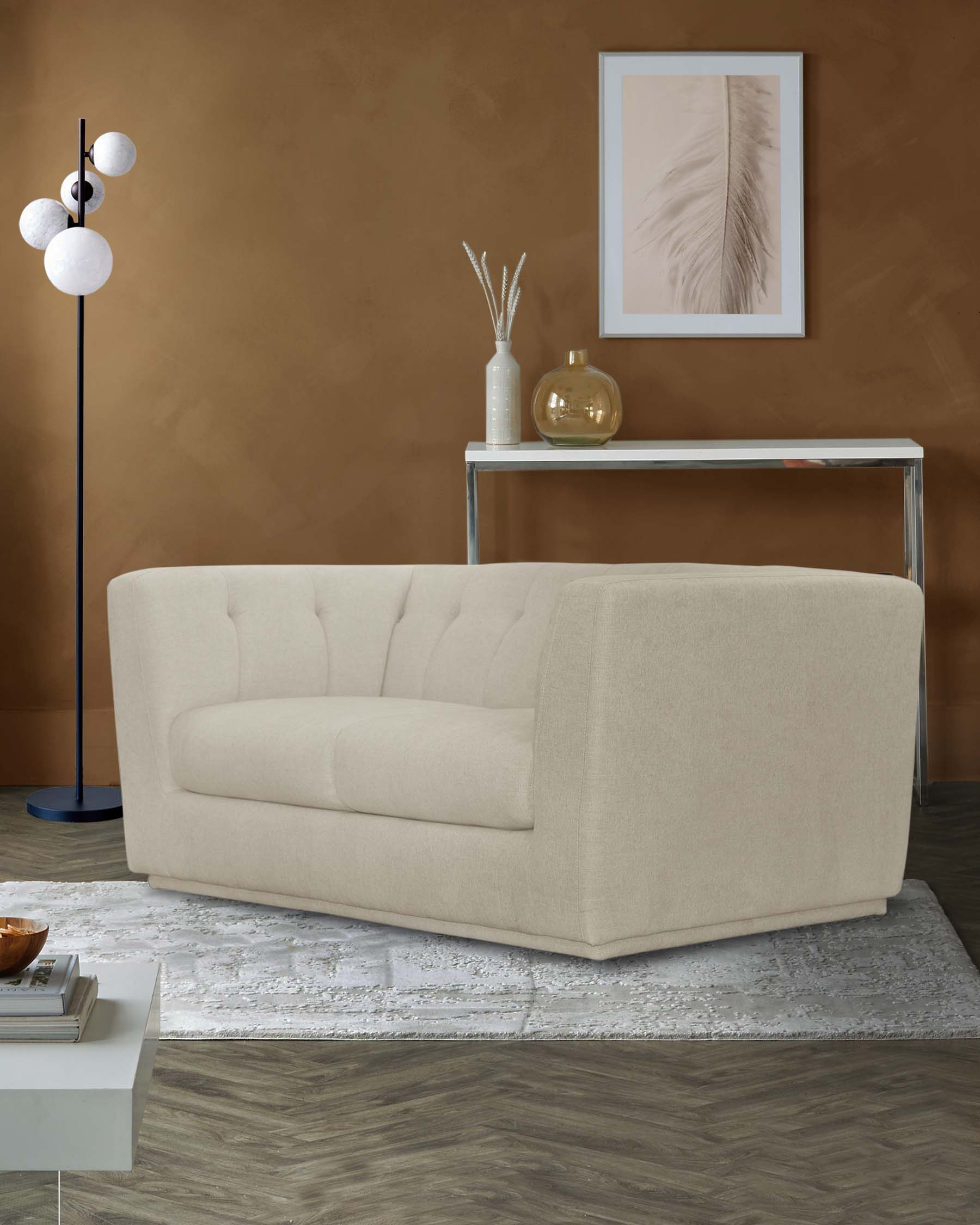 A modern, beige upholstered sofa with tufted design, complemented by a sleek console table, decorative vase, and stylish floor lamp.