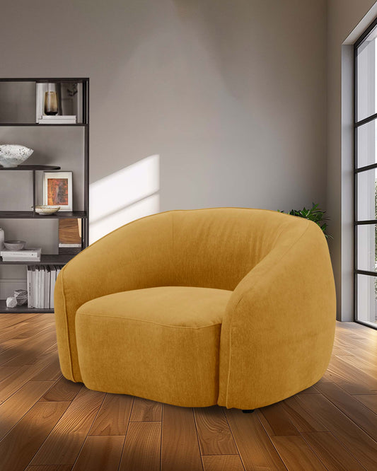 A cozy yellow upholstered chair with a rounded design, set against a backdrop of warm wooden flooring and minimalist decor.