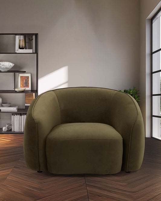 A plush, olive-green upholstered armchair with a rounded design, set against a backdrop of contemporary decor.