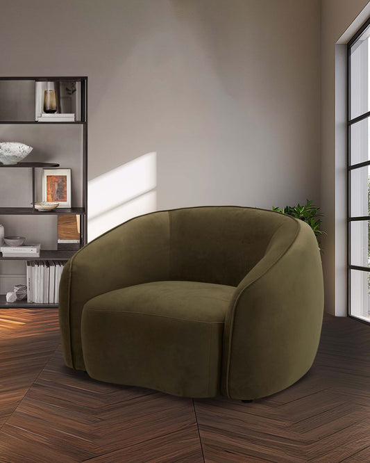 A plush olive green chair with curved arms, placed against a neutral wall, alongside a sleek black shelf.