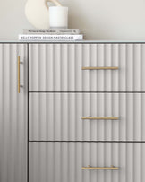 Modern fluted grey sideboard with brushed gold horizontal handles.