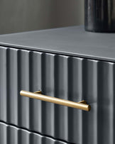 Contemporary dark grey chest of drawers featuring a textured vertical rib design and a brushed gold metal handle.