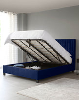 Modern navy upholstered bed with a lifting mechanism for storage, featuring a stylish headboard and minimalistic design.