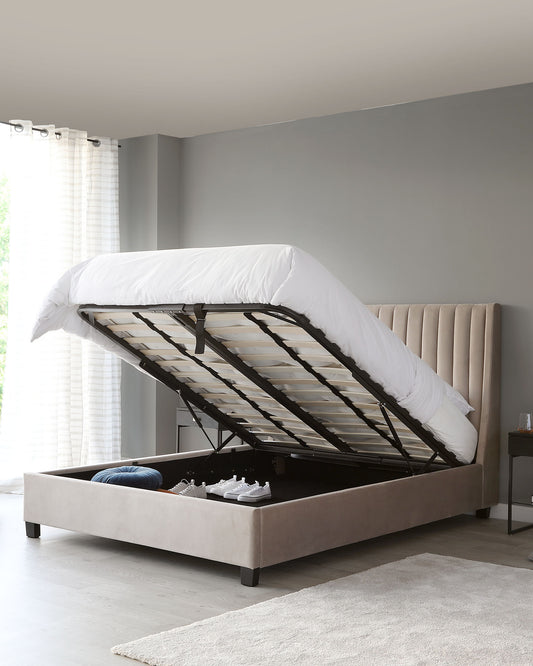 Contemporary taupe upholstered storage bed with a tufted headboard design and a gas-lift mechanism revealing under-bed storage space.