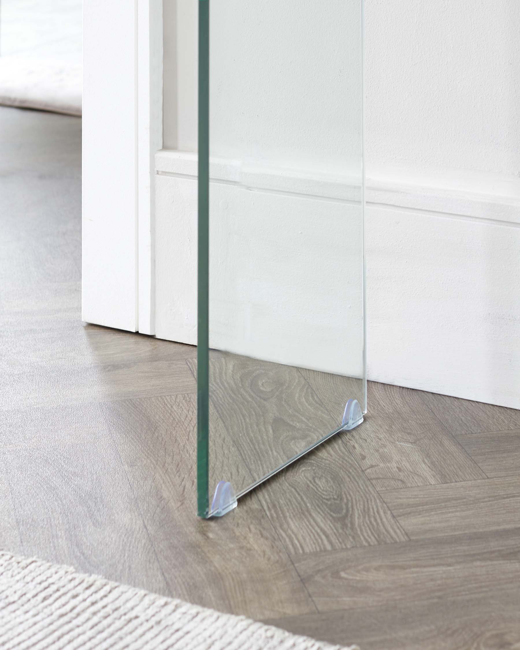 Modern minimalist glass doorstop with sleek metal accents.