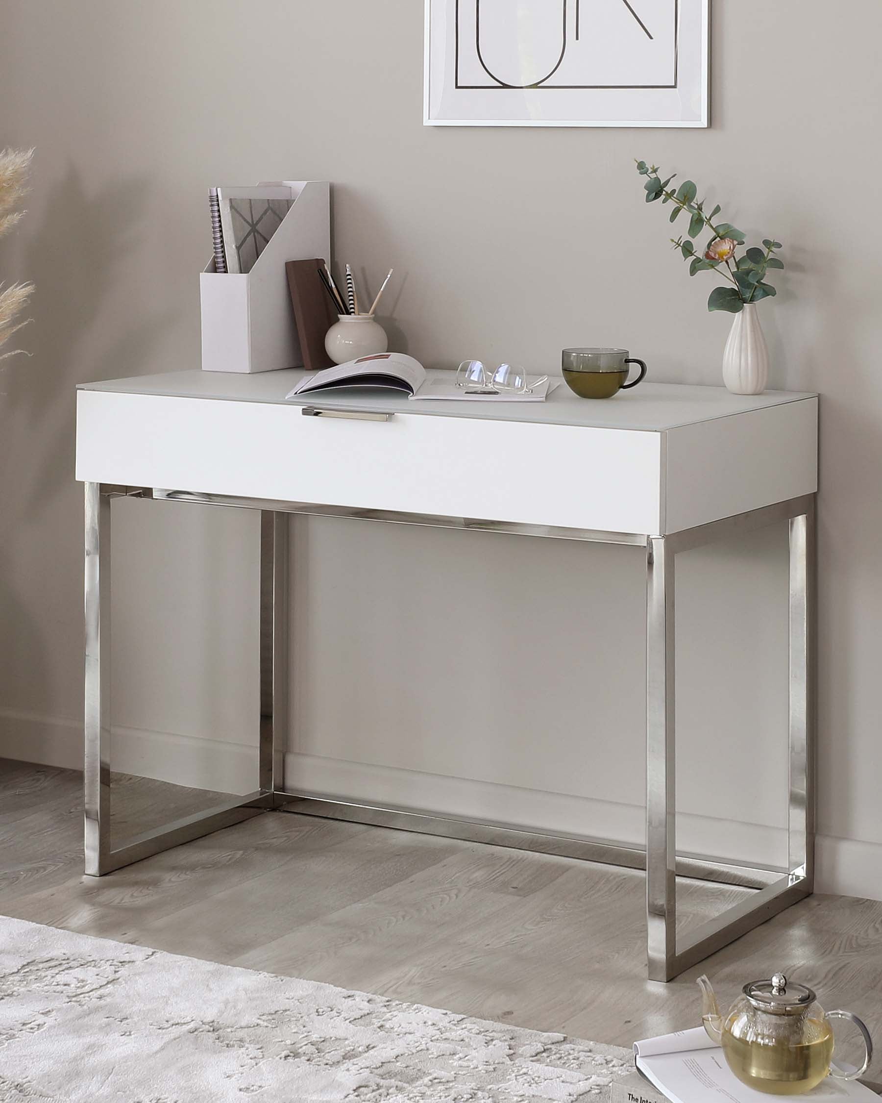 Modern white console table with a minimalist design, featuring a sleek white tabletop supported by polished chrome-finished metal legs.