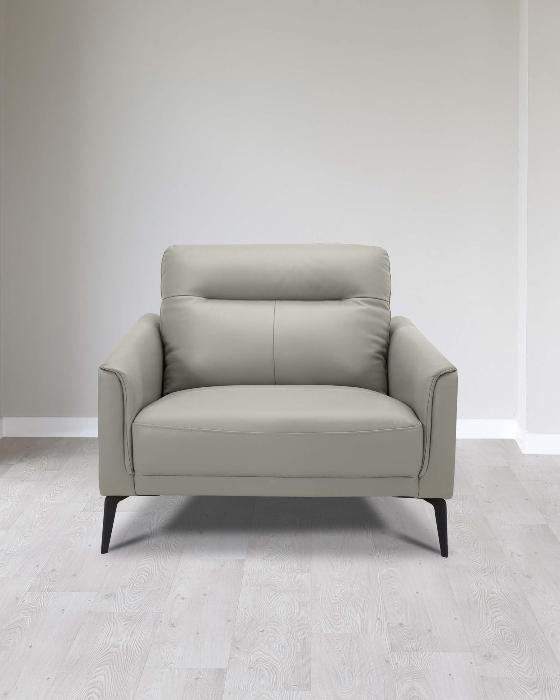 Modern light grey upholstered loveseat with a clean, minimalist design and slender black legs, set against a light wooden floor and a plain white wall.