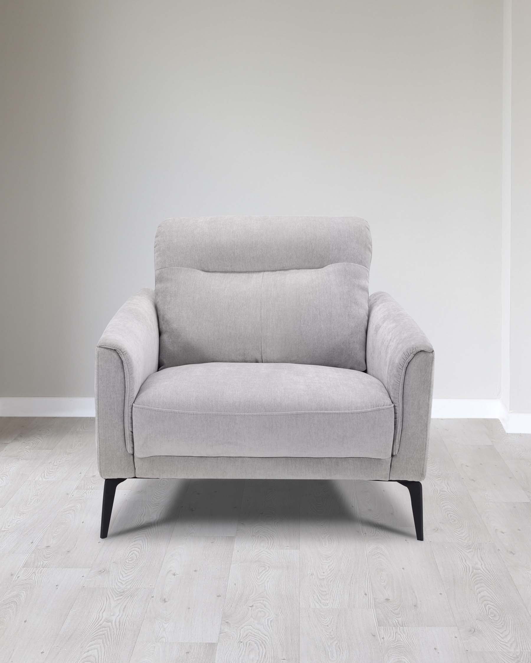 Modern light grey fabric loveseat with clean lines, thick cushioning, and black metal legs set in a minimalist room with light wooden flooring and pale grey walls.