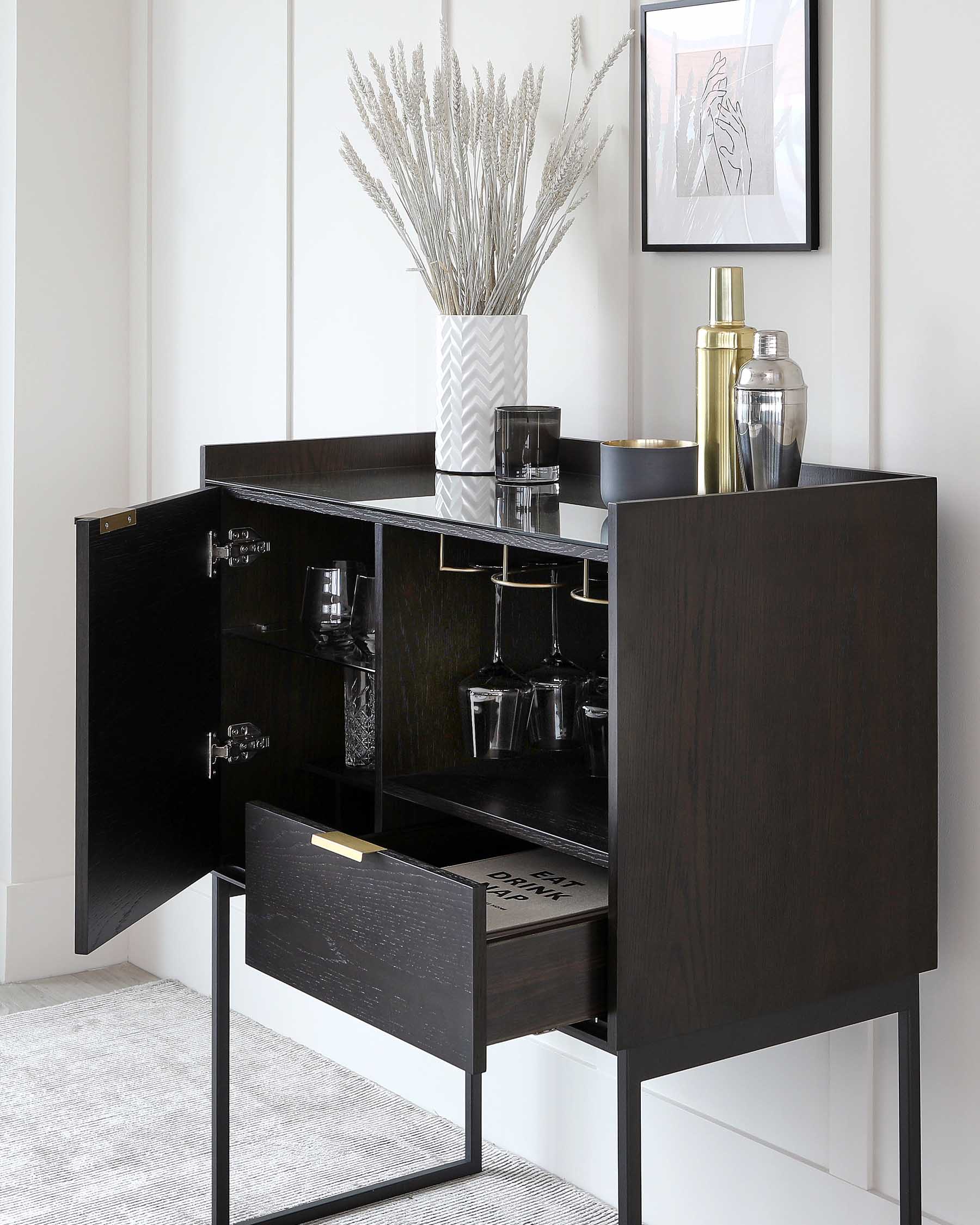 Contemporary black wood bar cabinet, featuring a rectangular silhouette with a dark finish, mounted on a sleek, black metal frame. Two doors, one drawer, and visible shelving are open to reveal interior storage with compartments for glassware and bottles, accented by gold-toned hardware.