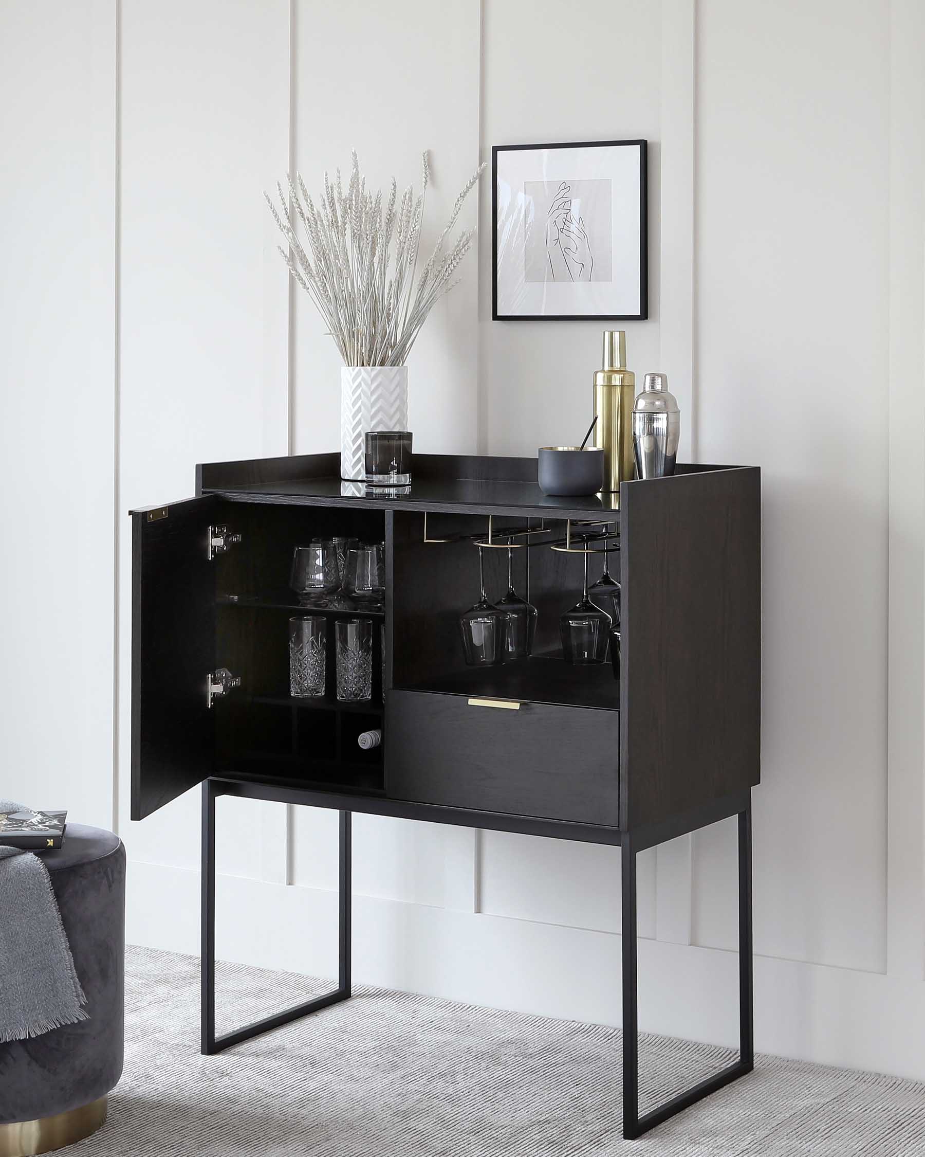 Modern black bar cabinet with sleek metal frame, glassware shelves, and a wine glass holder, complemented by decorative objects on top and an artwork piece above.