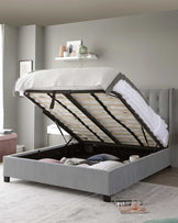 A contemporary grey upholstered storage bed with a button-tufted headboard and an easy-lift hydraulic system revealing ample under-mattress storage.