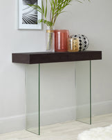 Modern minimalist console table with a dark wooden top and two clear glass pane supports.