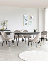 Modern dining room with a dark wooden table and six taupe upholstered chairs featuring sleek black legs with gold tips. A matching minimalistic dark wooden sideboard is placed to the side, adorned with decorative vases.