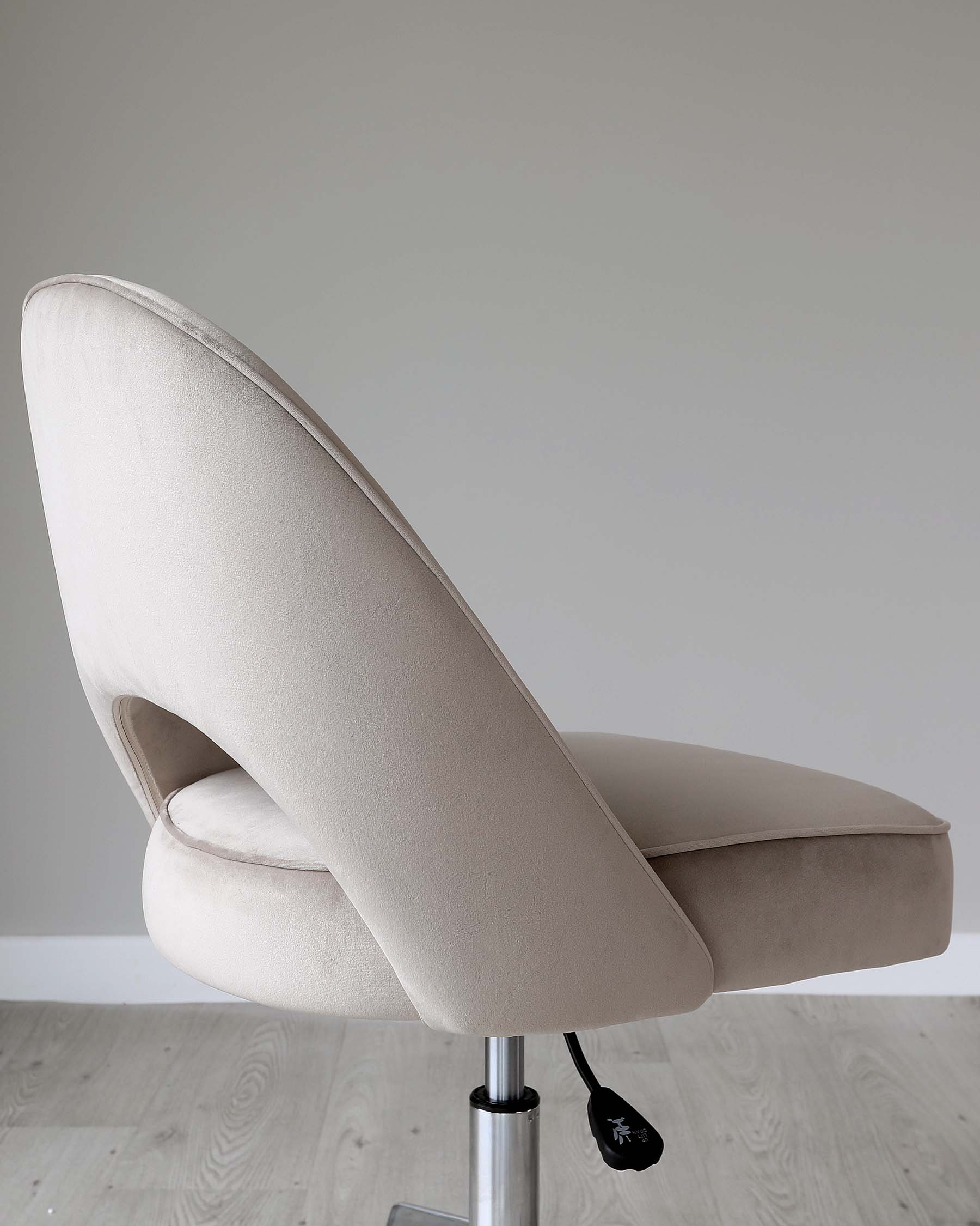 Modern beige upholstered swivel chair with a high back, curved design, and a metallic adjustable height lever on a five-point chrome base, set on a wooden floor against a grey background.