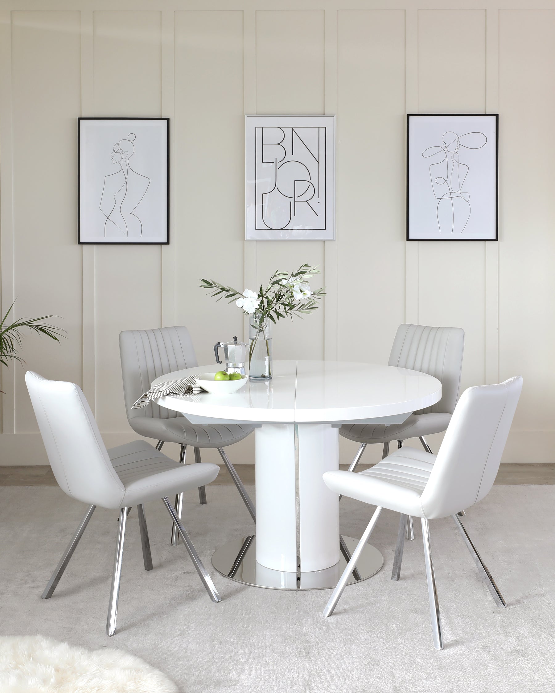 Modern dining set featuring a white circular table with a glossy finish and central pedestal base, accompanied by four sleek chairs with grey upholstered seats and backrests, and chrome-finished metal legs.