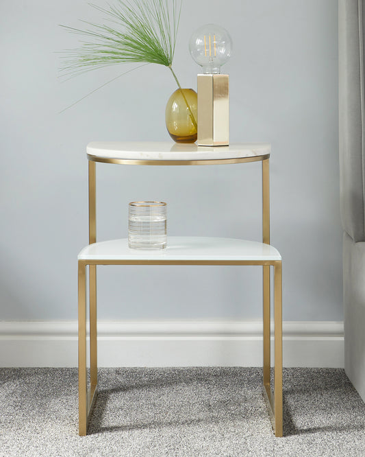 Elegant contemporary two-tier round side table with a white tabletop and gold-finished metal frame, featuring sleek lines and a minimalistic design.