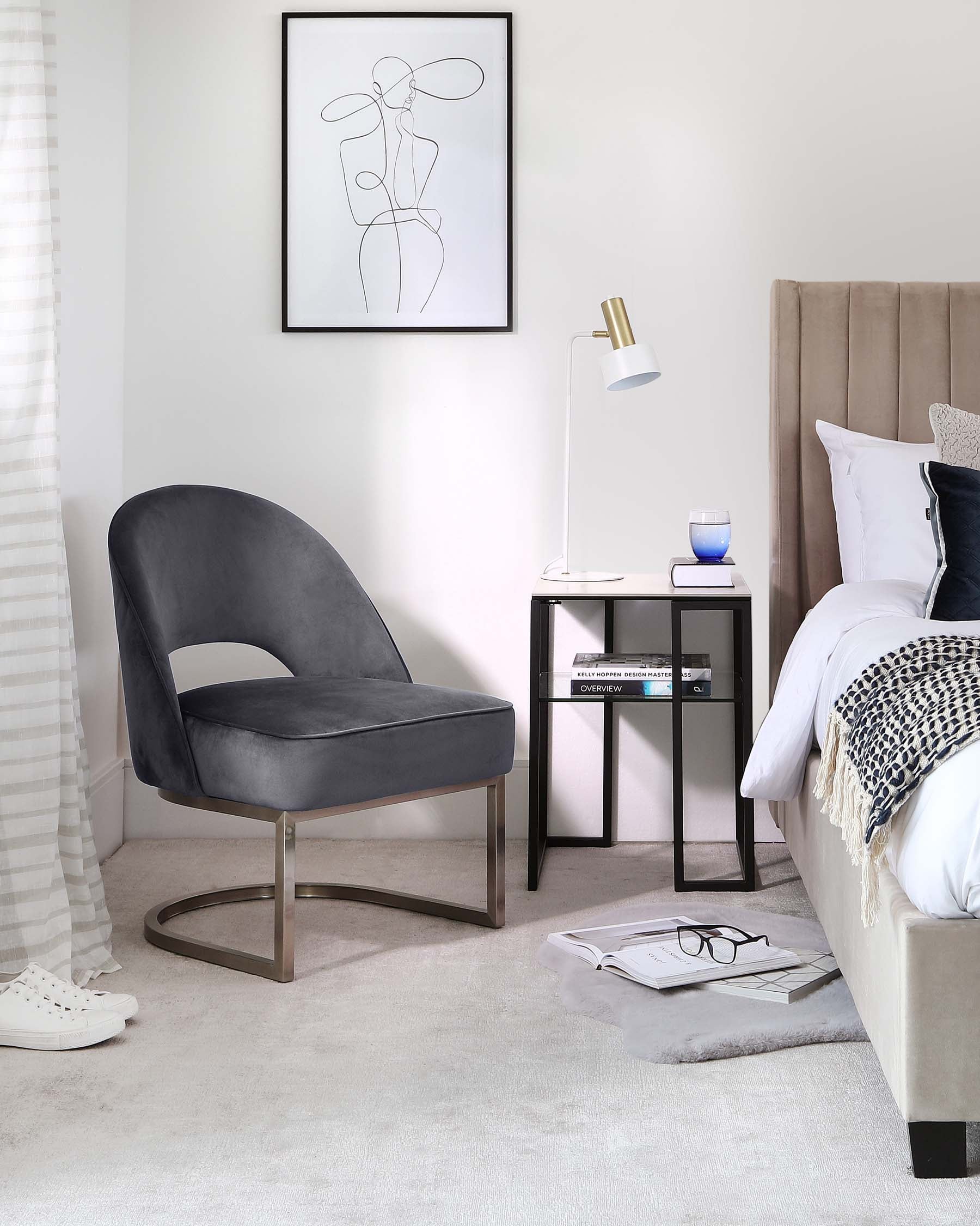 Elegant modern bedroom featuring a plush velvet accent chair with a unique curved metal base, a sleek bedside table with a mirrored finish and two tiers, a metal modernist table lamp, and a comfortable bed with an upholstered headboard. All pieces are set against a neutral colour palette with soft lighting and minimalist decor.