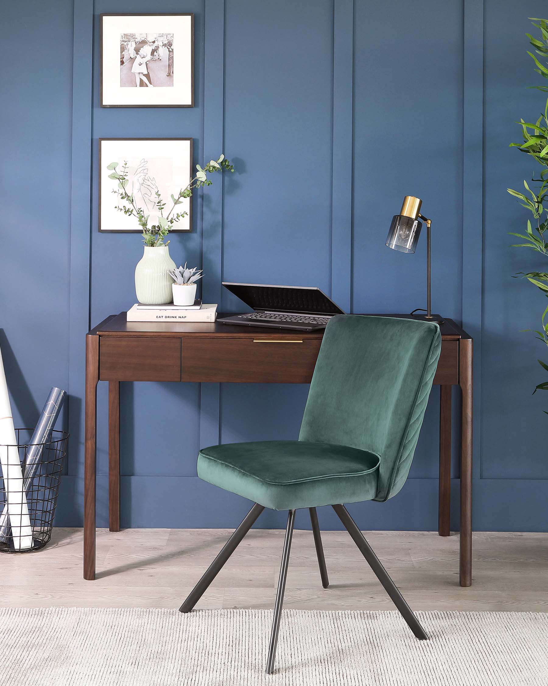 Elegant brown wooden writing desk with a sleek modern design, paired with a luxurious dark green velvet chair featuring metal legs.