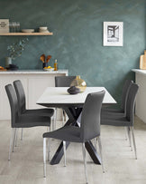 Modern dining set featuring a white rectangular table with a distinctive black X-shaped base and four sleek, dark grey upholstered chairs with chrome legs.