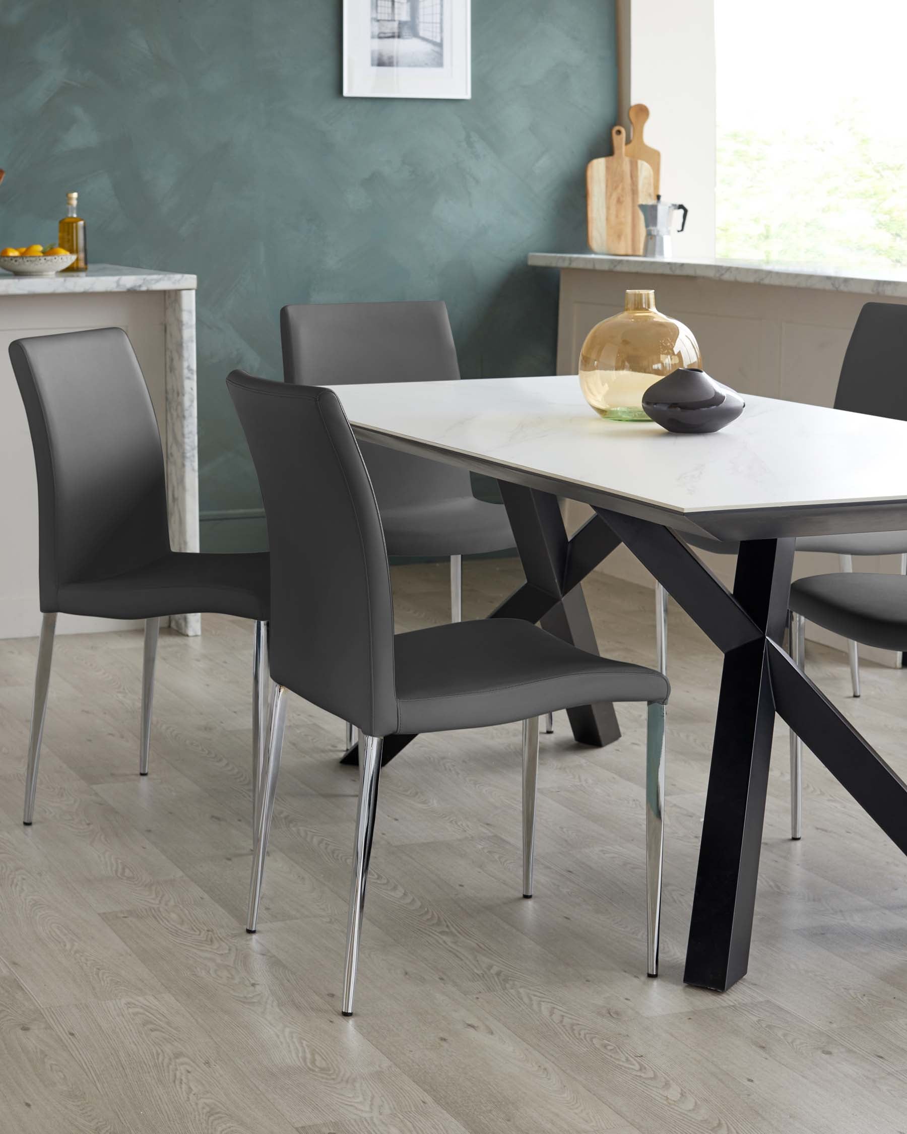 Modern dining room furniture set, comprising a sleek rectangular marble-top table with stark black angular legs, paired with four minimalist grey upholstered chairs featuring chrome legs.