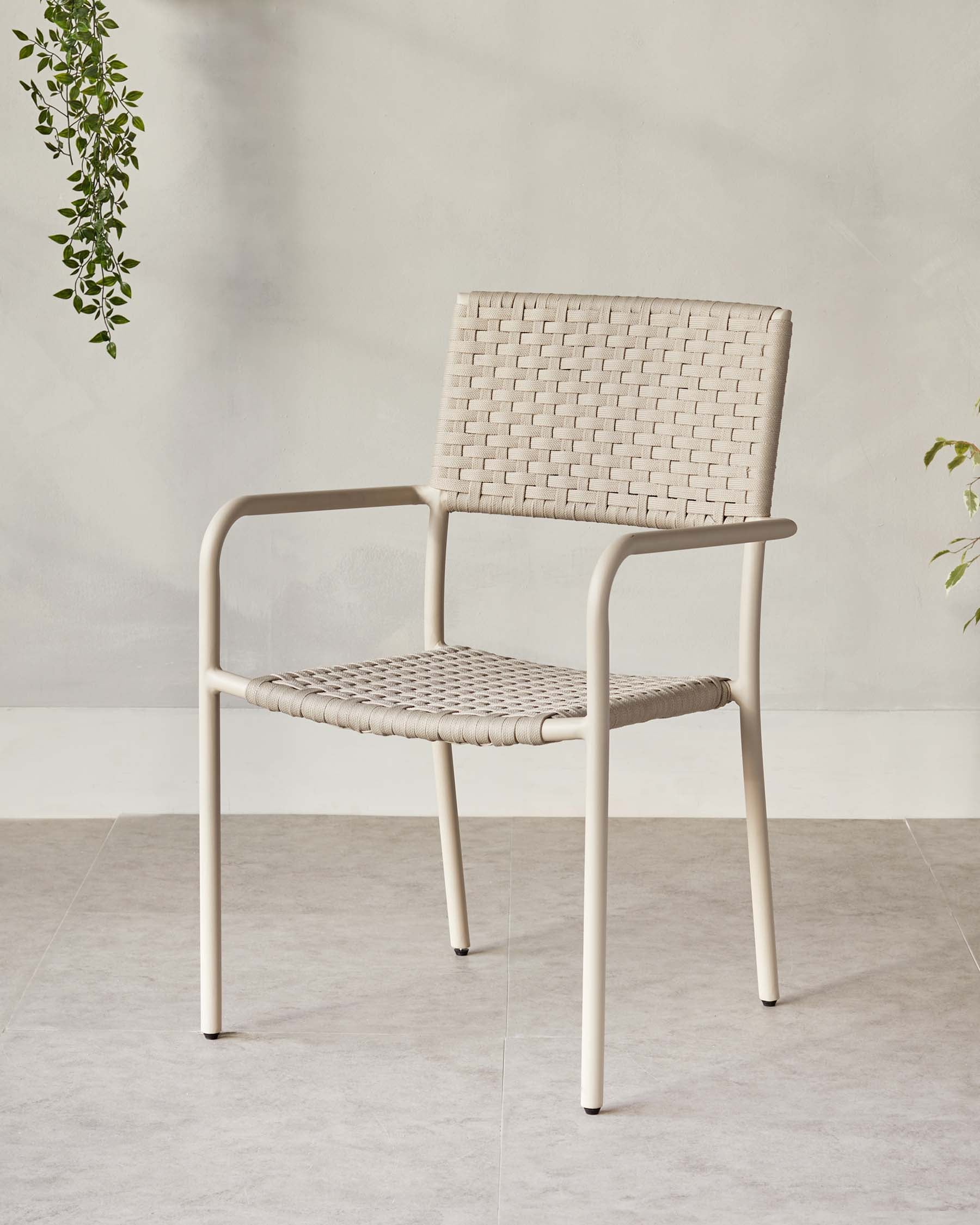 Modern minimalist chair with a light beige metal frame and woven seat and backrest, set against a neutral background.