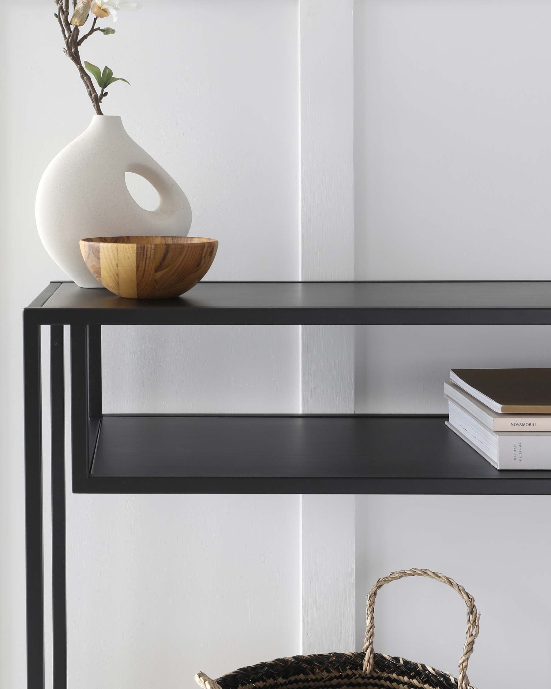 Modern minimalist black metal console table with a sleek rectangular silhouette, featuring two open shelves with a matte finish.