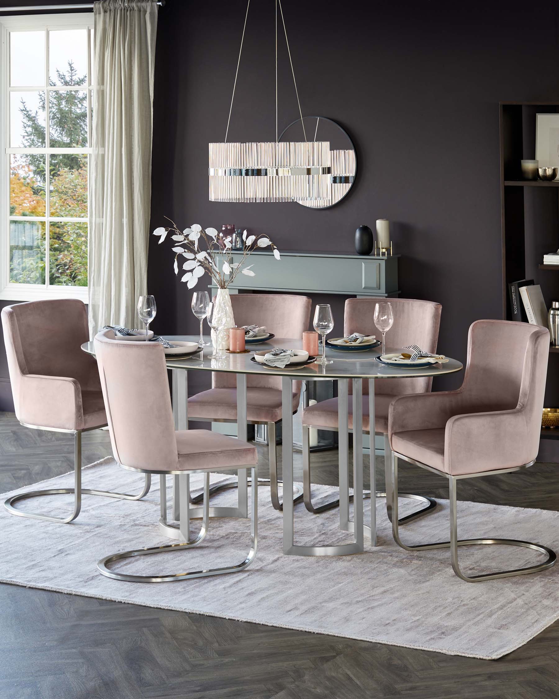 A contemporary dining set featuring a round glass-top table with a sleek metallic base, complemented by four plush velvet-upholstered chairs in a muted pink tone with unique cantilevered metal frames.