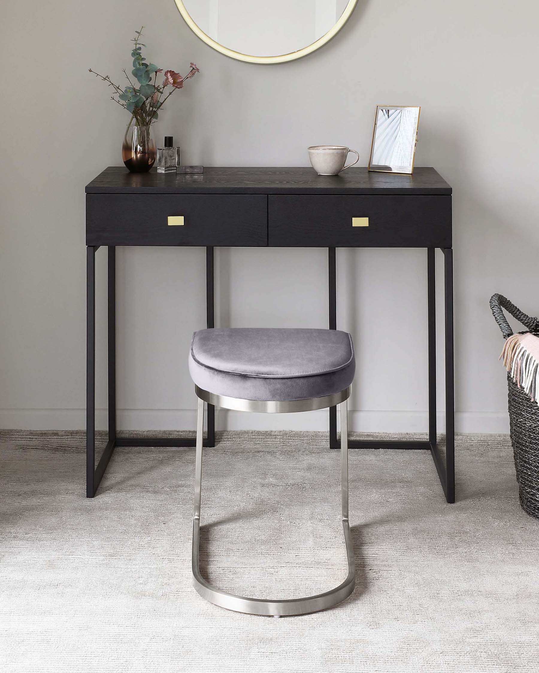 Contemporary black console table with golden drawer pulls, paired with a modern grey upholstered stool with a semi-circular metallic base. The console displays two drawers and slim, straight legs, complemented by a round mirror above.