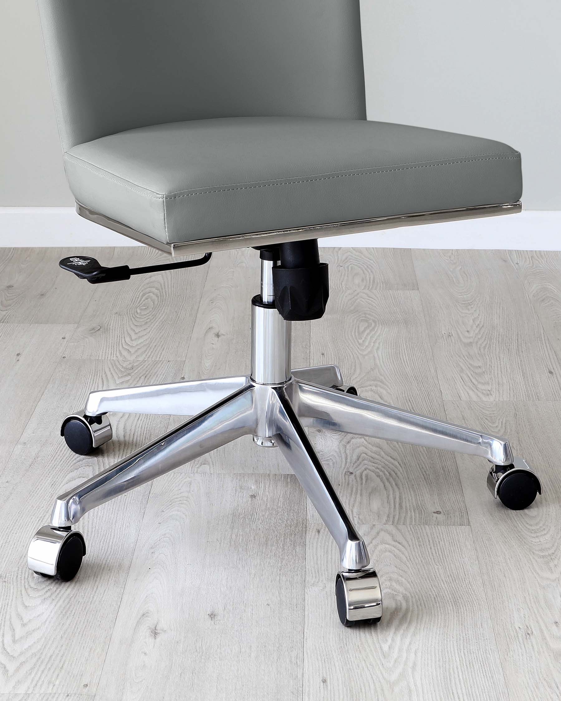 Modern office chair with a grey leather upholstery, featuring a padded seat and backrest. The chair includes a gas lift adjustment lever on the side for height control, and is mounted on a shiny chrome base with five caster wheels for mobility.