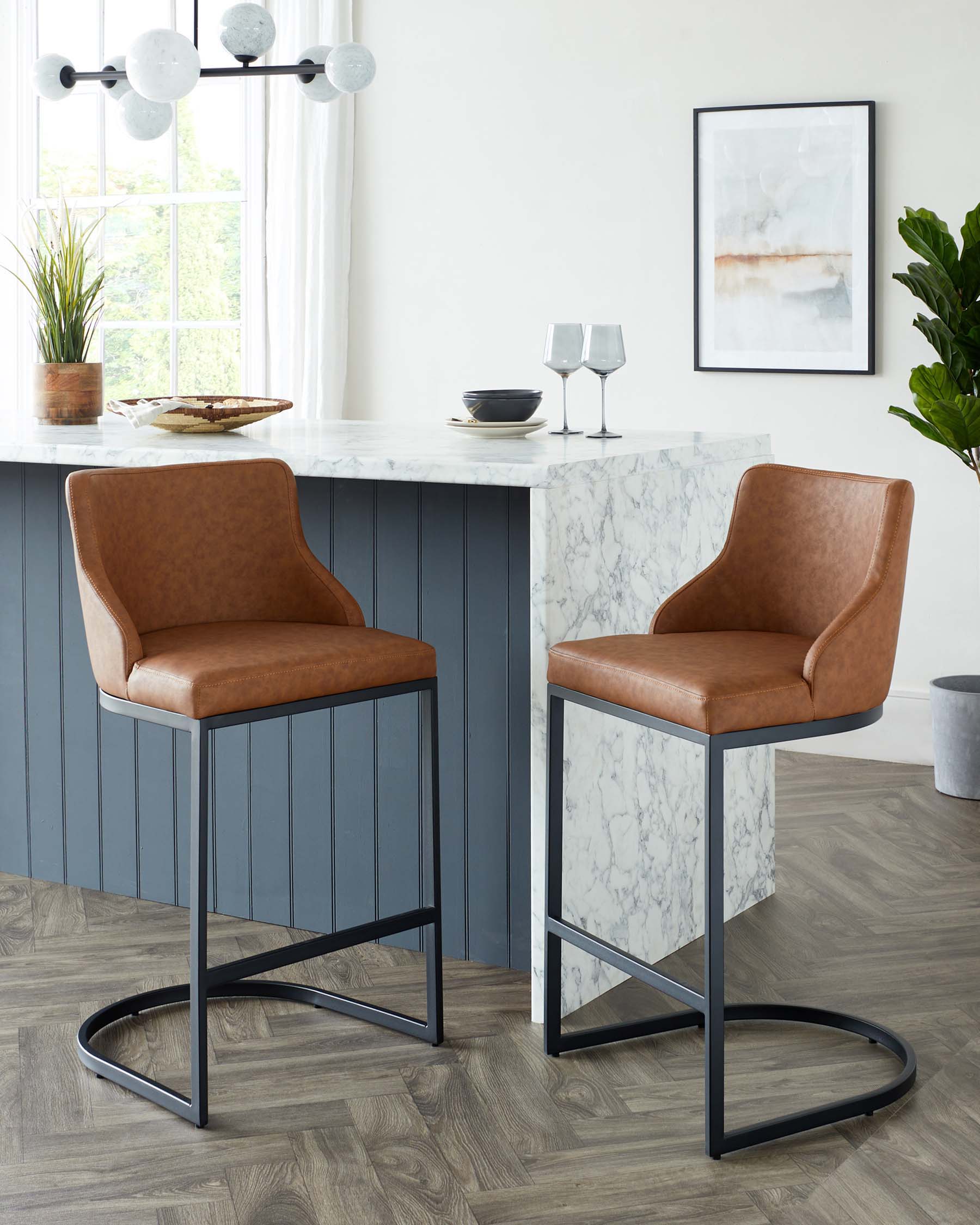 Two modern bar stools with sleek brown faux leather upholstery and metal legs in a matte black finish, positioned at a marble-topped kitchen island in an elegant room with a contemporary aesthetic.