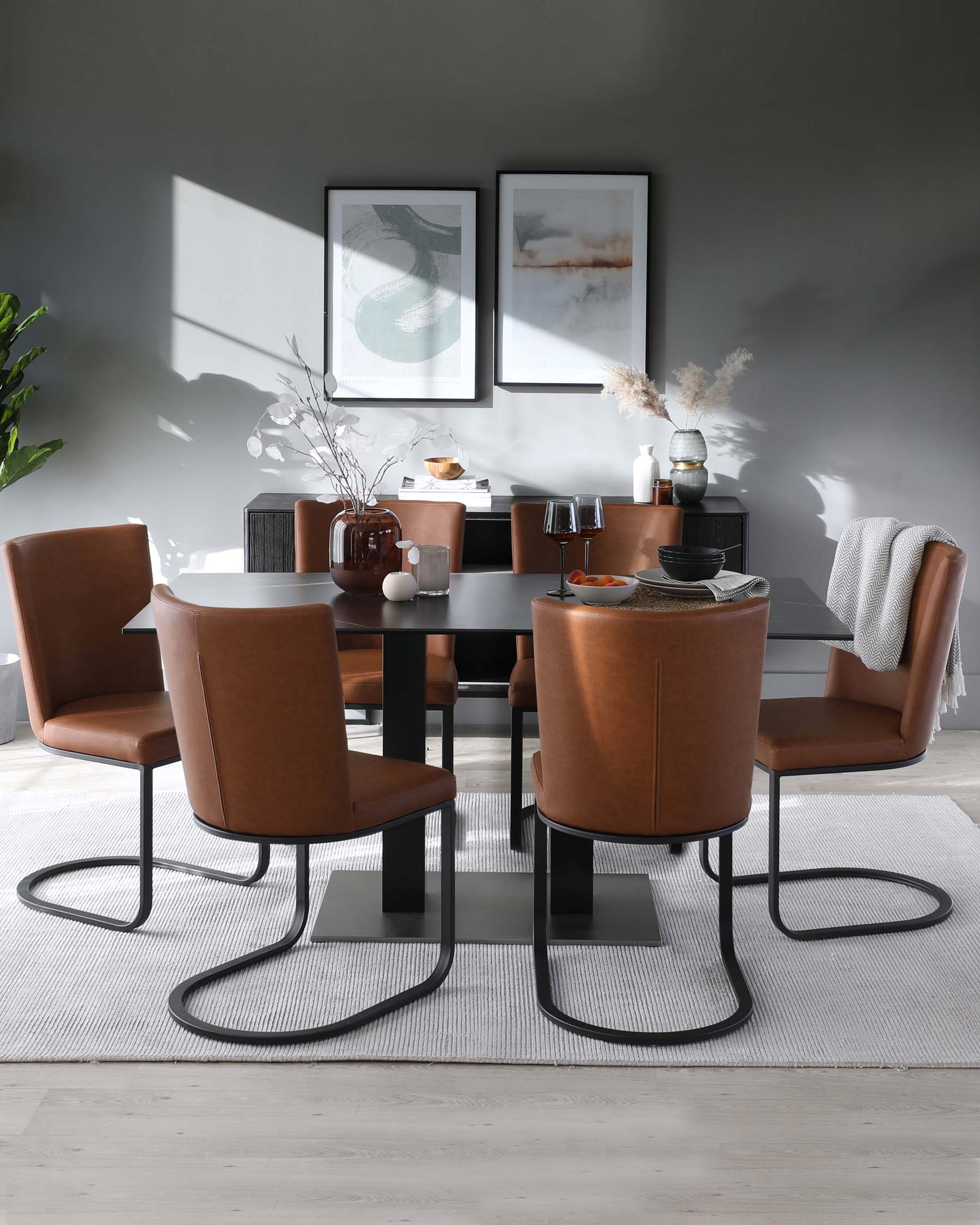 A modern dining room set featuring a rectangular black table with a glossy finish, surrounded by four caramel brown leather chairs with a curved back design and unique black metal sled bases. The set is placed on a textured grey and white area rug.