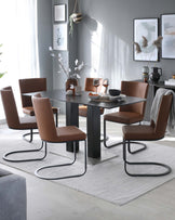 Modern dining room set featuring a rectangular table with a matte grey finish and sturdy black block legs, complemented by six cantilever dining chairs upholstered in caramel-brown leatherette with unique s-shaped black metal frames, all displayed on a textured light grey area rug.