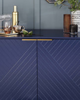 Elegant navy blue sideboard with herringbone patterned doors and a sleek black countertop, featuring thin, minimalist handles.