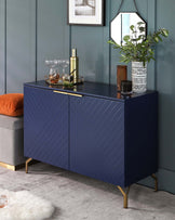 A modern navy blue sideboard cabinet with chevron-patterned front panels, accented with brass-finished metal legs and matching handles.