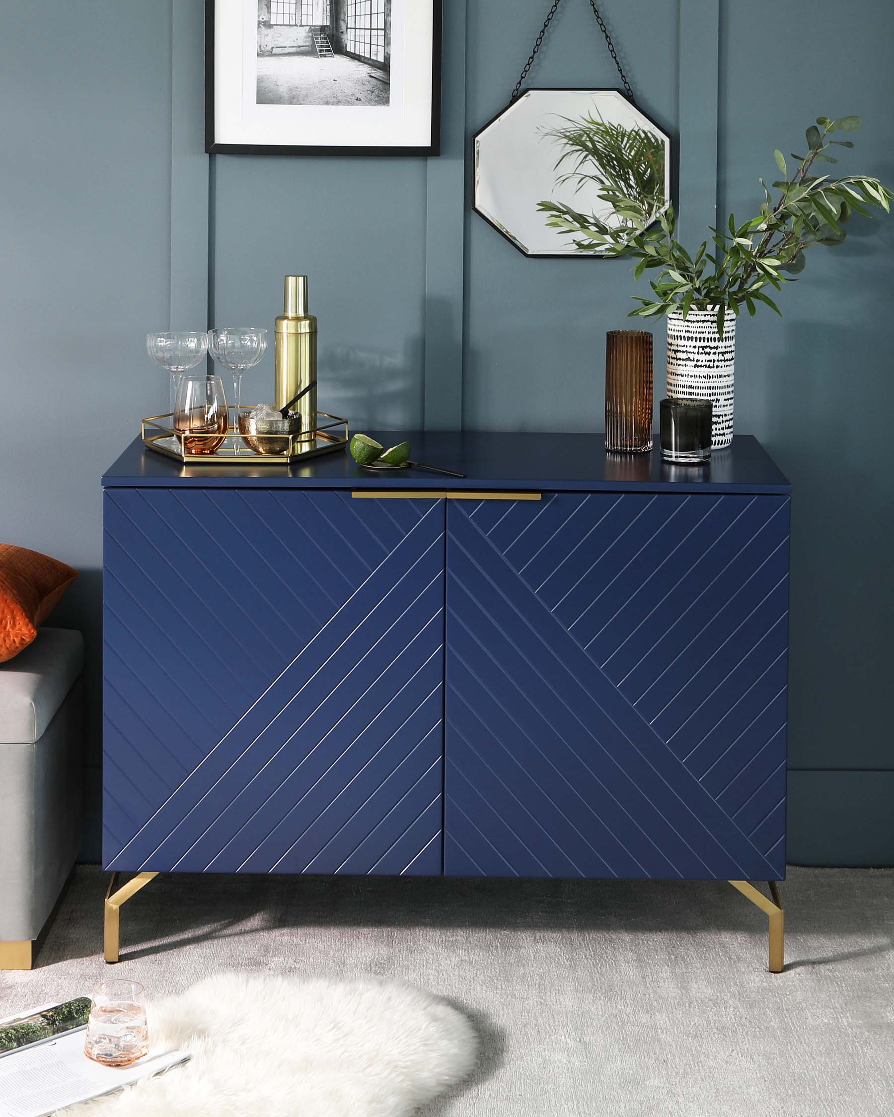 Elegant navy blue sideboard cabinet with diagonal groove pattern and brass leg accents, suitable for contemporary home decor.