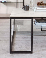 Modern rectangular side table with a faux marble top and black metal frame, including a lower glass shelf.