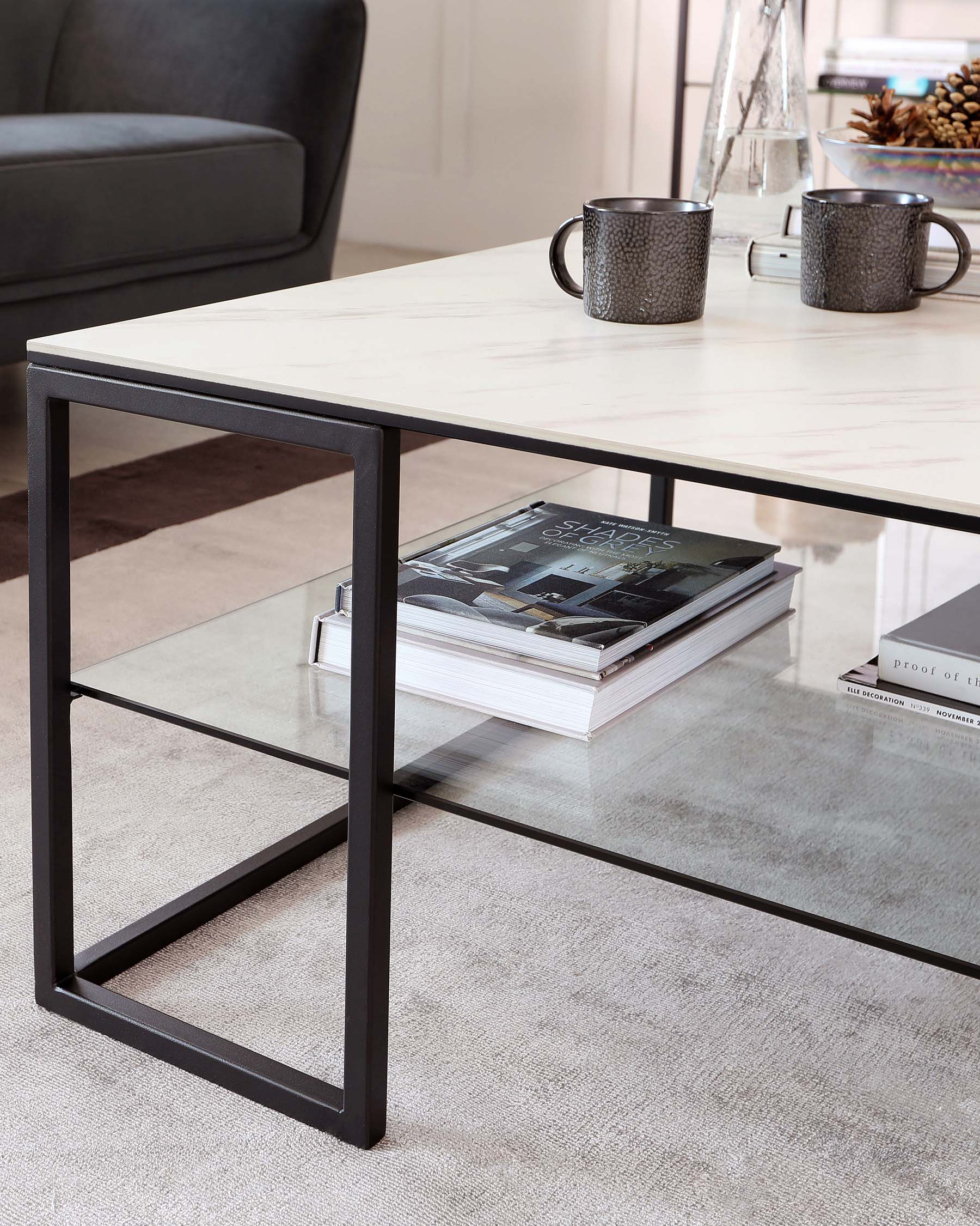 Modern minimalist coffee table with a faux marble top and sleek black metal frame. Features a lower shelf for additional storage or display, situated in a cosy living space.