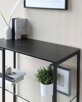 Modern console table with a black faux marble top and a metal frame, featuring a lower glass shelf for additional display and storage space.