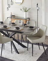 Modern dining set featuring a sleek gray table, upholstered chairs with ribbed backs, and elegant tableware on a rug.