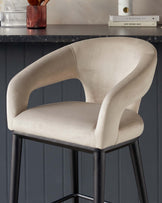 Modern upholstered bar stool with beige fabric and curved backrest on sleek black metal legs.