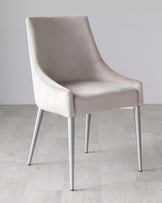 Modern light grey upholstered dining chair with a high back and armrests, featuring vertical stitching on the backrest, and set on four sleek, cylindrical, chrome legs. The chair is placed on a light wooden floor with a plain white wall in the background.