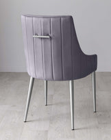 Elegant contemporary dining chair with a high, curved backrest, featuring vertical stitching detail and a polished chrome handle, complemented by sleek, tapered metal legs. The chair is upholstered in a plush, muted purple fabric, offering a sophisticated seating option for modern interiors.