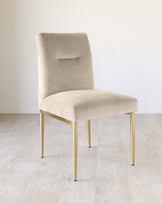 Modern beige velvet dining chair with a minimalist design and slender gold metal legs.