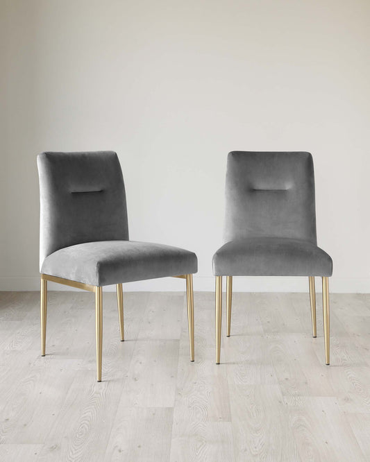 Two modern grey velvet dining chairs with sleek gold metal legs, featuring a simple and elegant design with a small cut-out detail on the backrest.