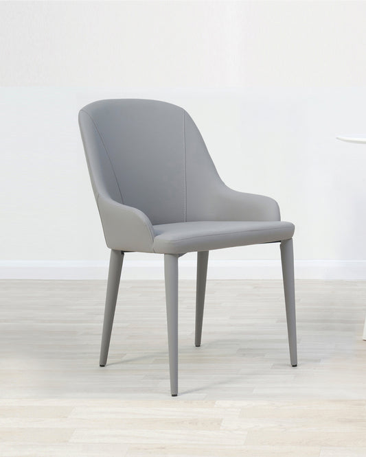 Modern grey dining chair with upholstered seat and backrest, featuring a curved silhouette and streamlined metal legs.